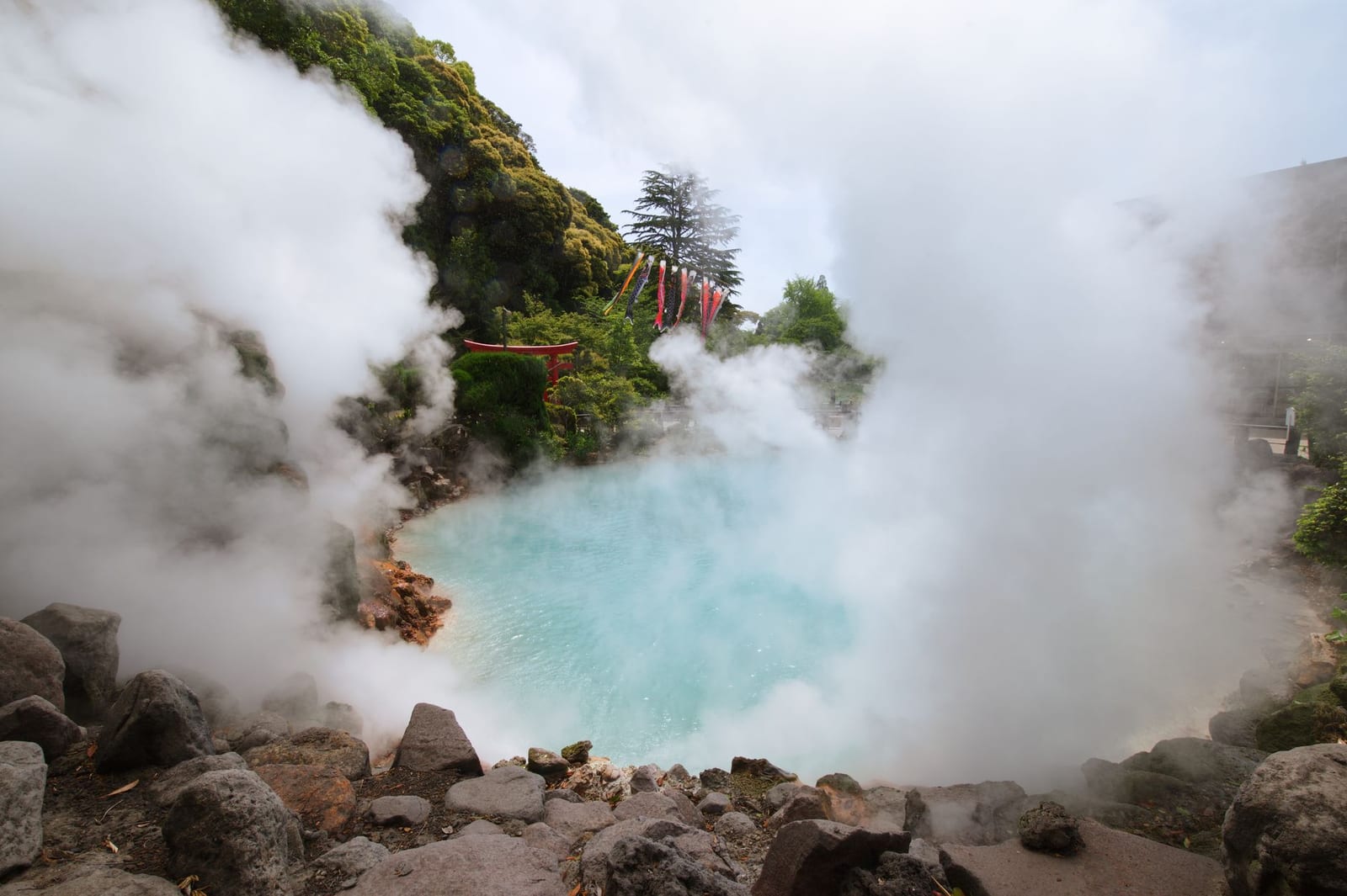 Steam rising from a coloured hot spring pool on the Beppu Hells circuit