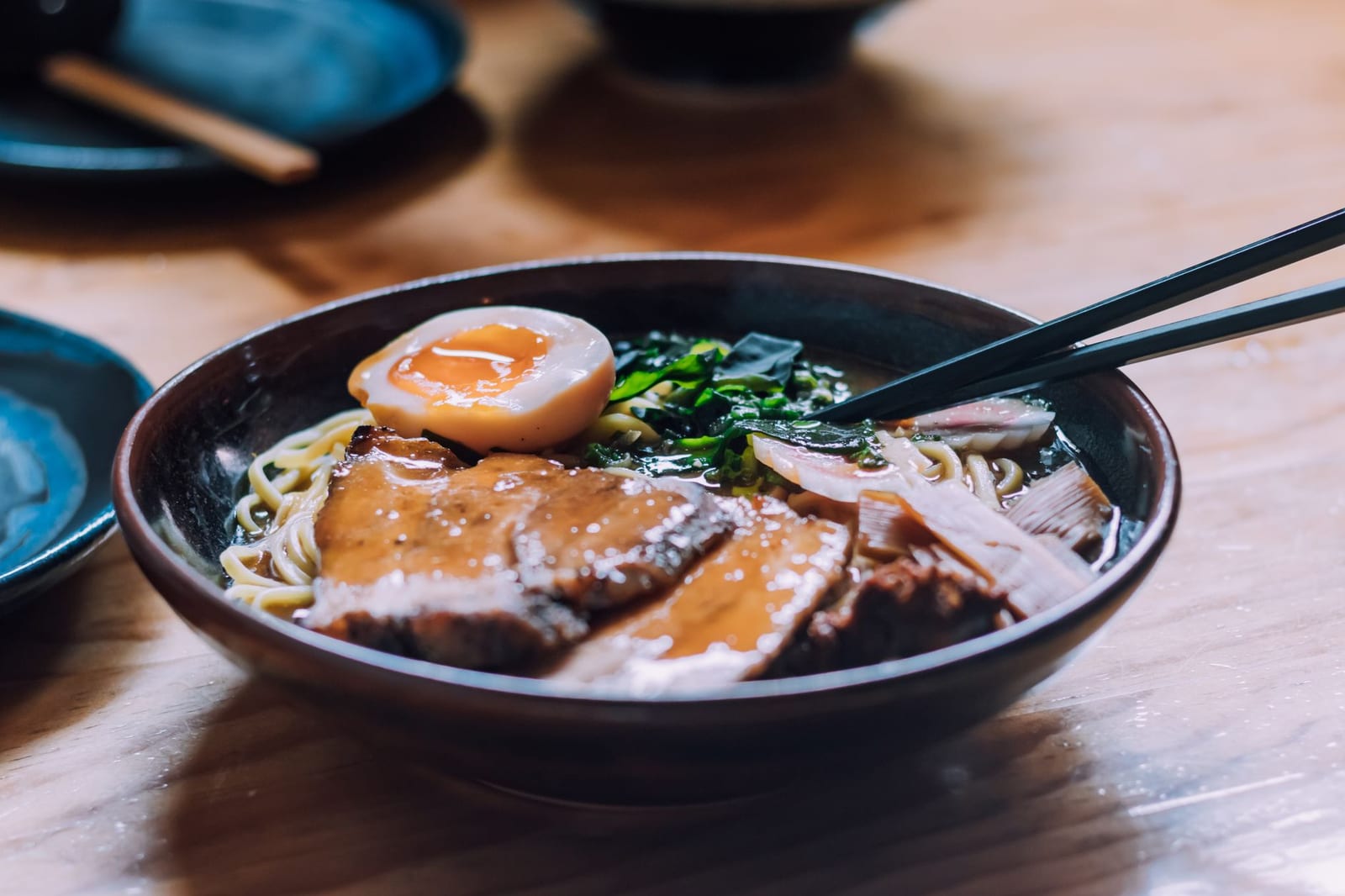 Bowl of Japanese ramen with sliced pork, egg and spring onion