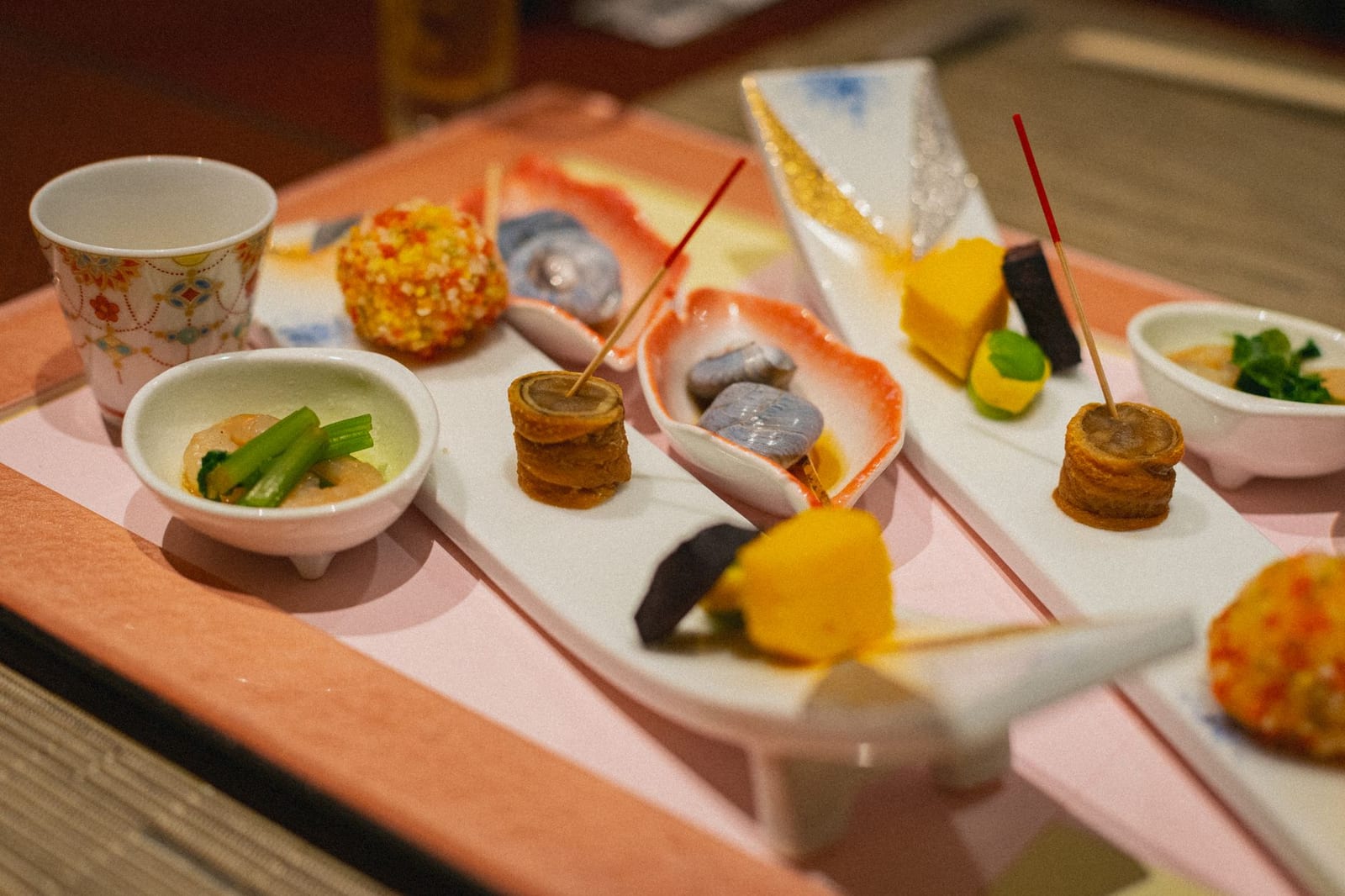 Multi-course Japanese kaiseki dinner of small seasonal dishes arranged on a table