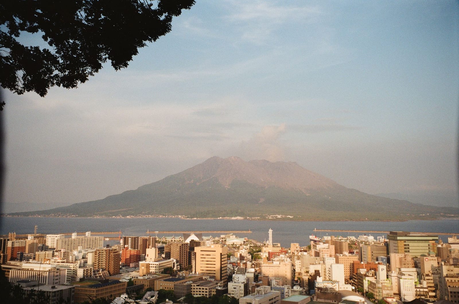 Sakurajima volcano rising beyond the Kagoshima cityscape