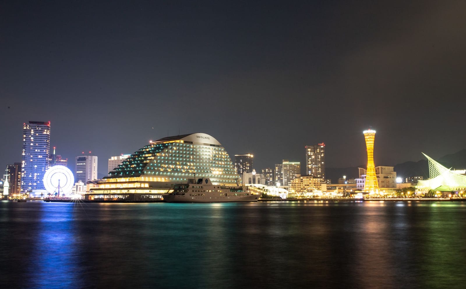 Kobe harbour at night with the illuminated skyline reflected in the water