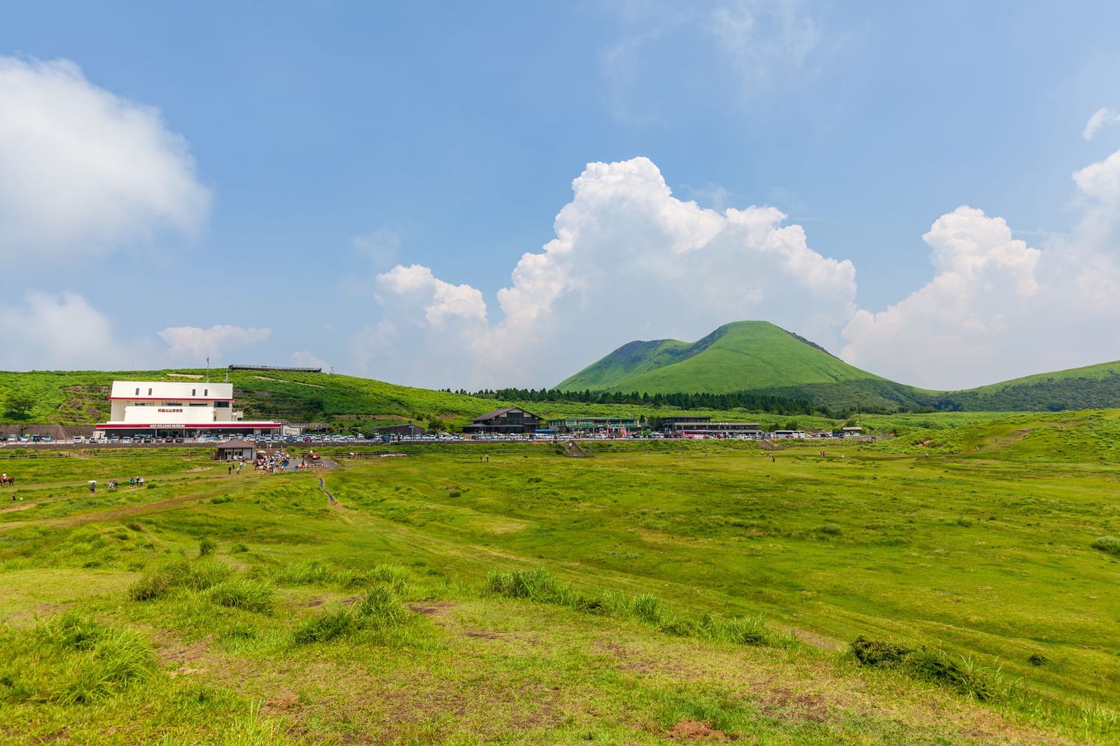 Green volcanic hills of the Aso caldera under a blue sky in Kyushu
