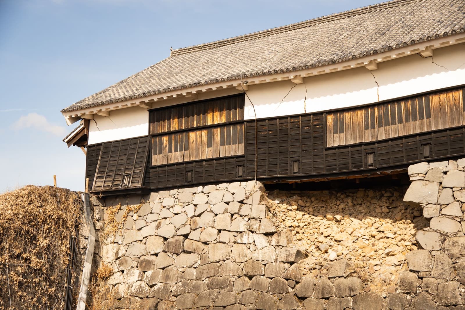 Timber turret above the curved stone rampart of Kumamoto Castle