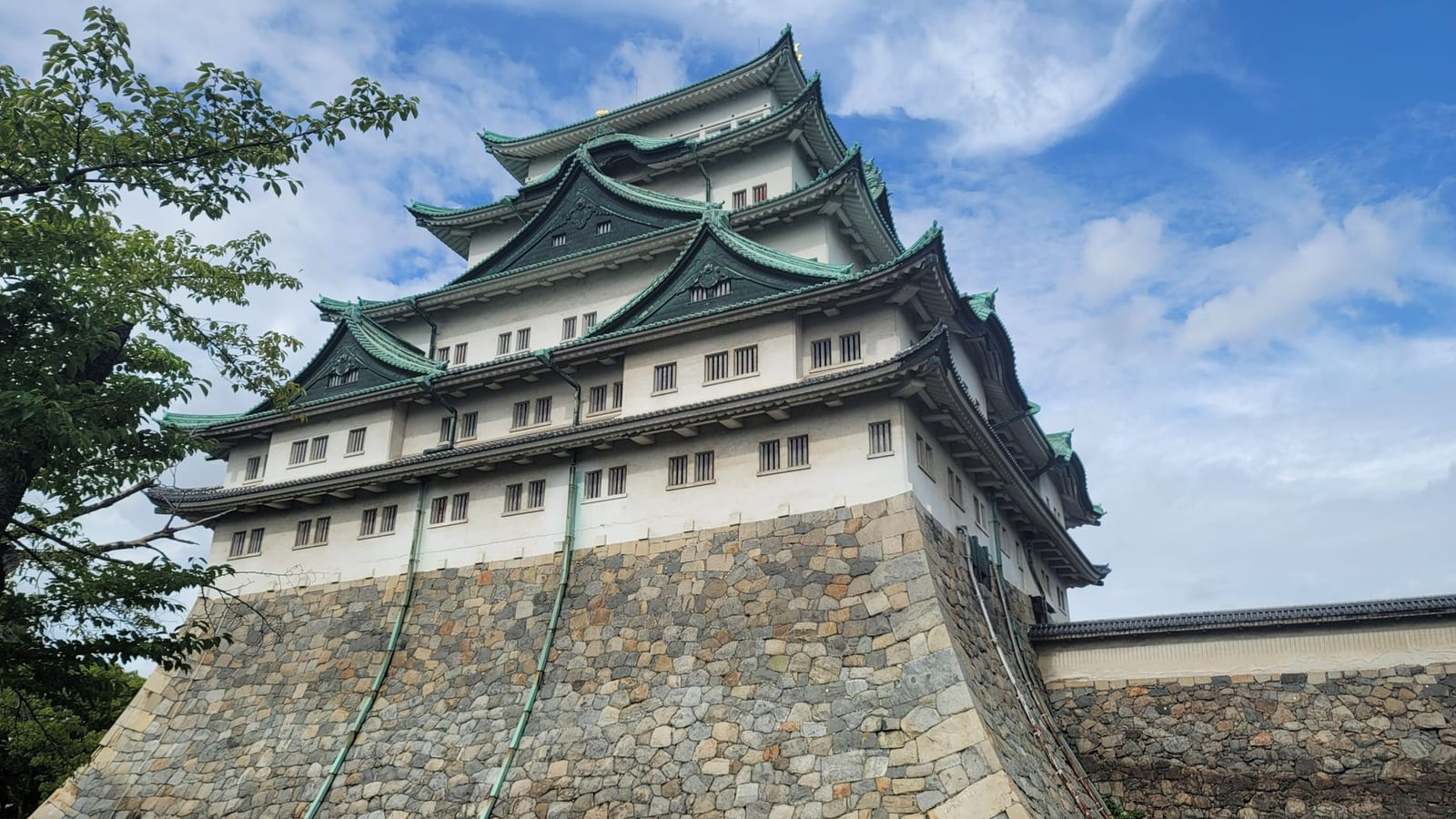 Nagoya Castle keep and its tiled roofs under a clear sky