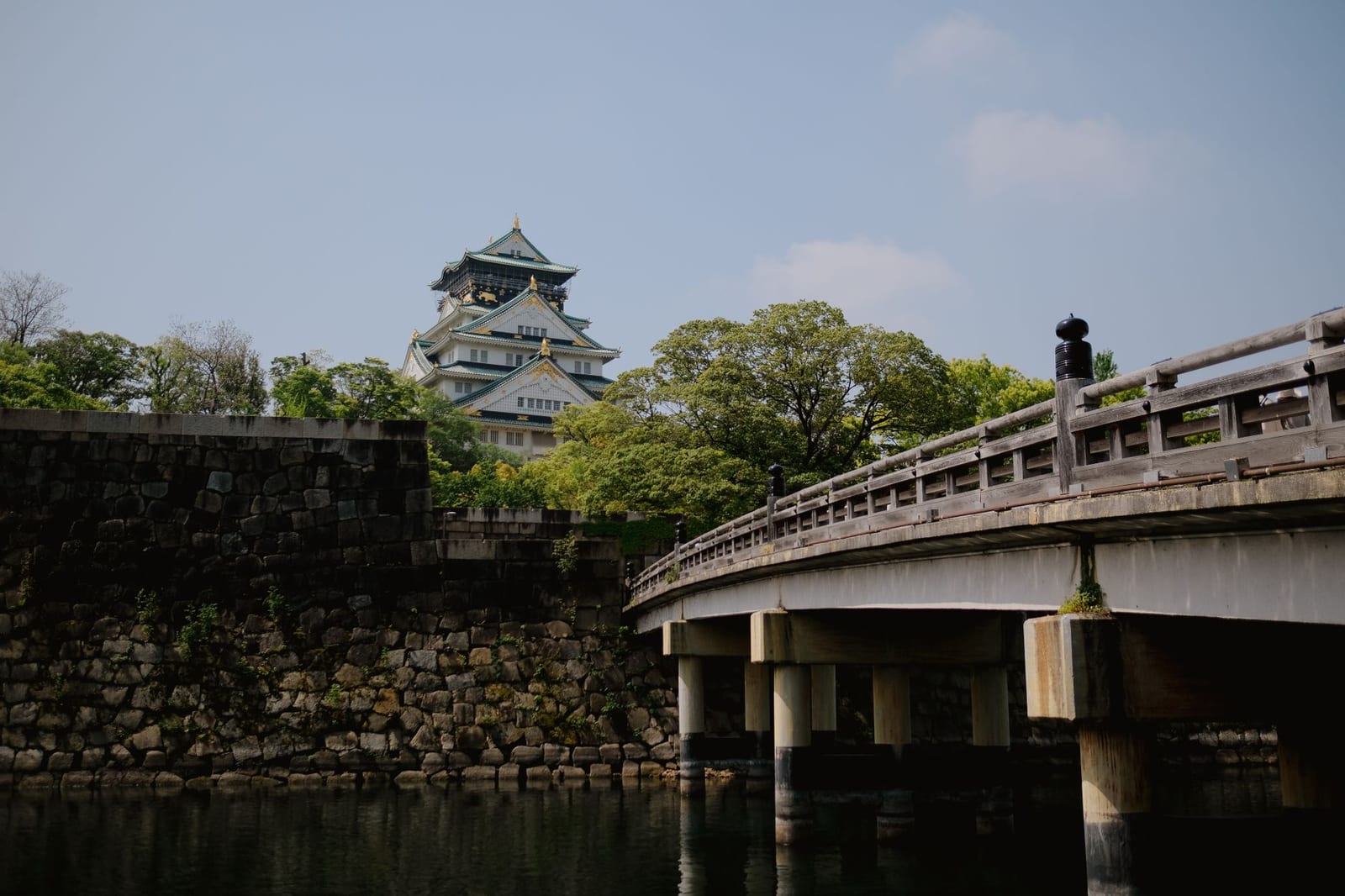 Osaka Castle main keep seen across the moat and stone walls