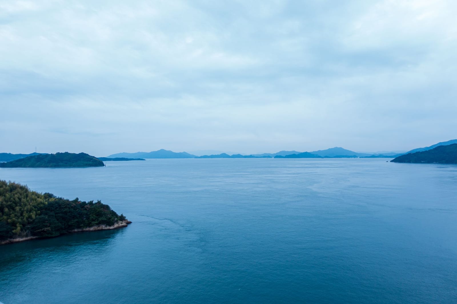 Wooded islands scattered across the blue water of the Seto Inland Sea