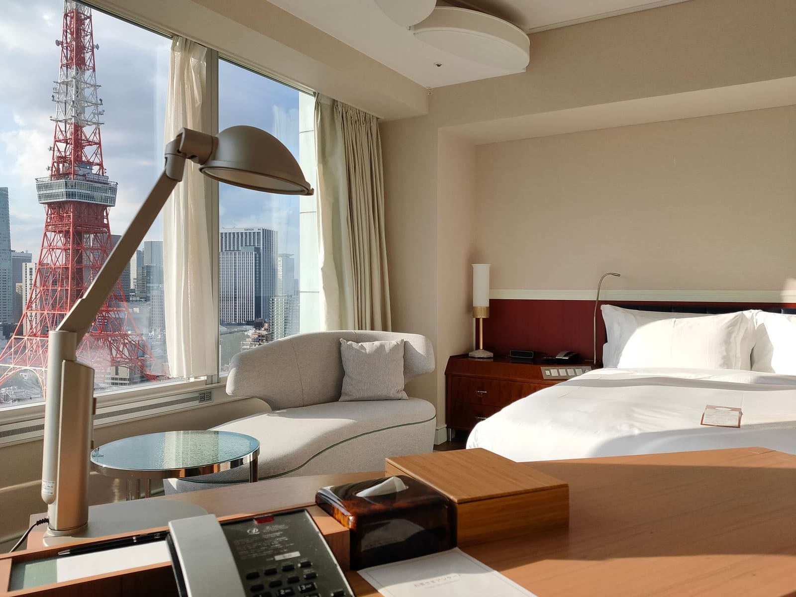 Hotel room in Tokyo with a wide window looking out over the city towards Tokyo Tower