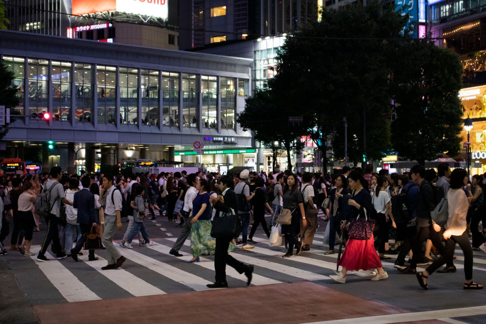 Pedestrians crossing Shibuya scramble intersection in Tokyo at street level