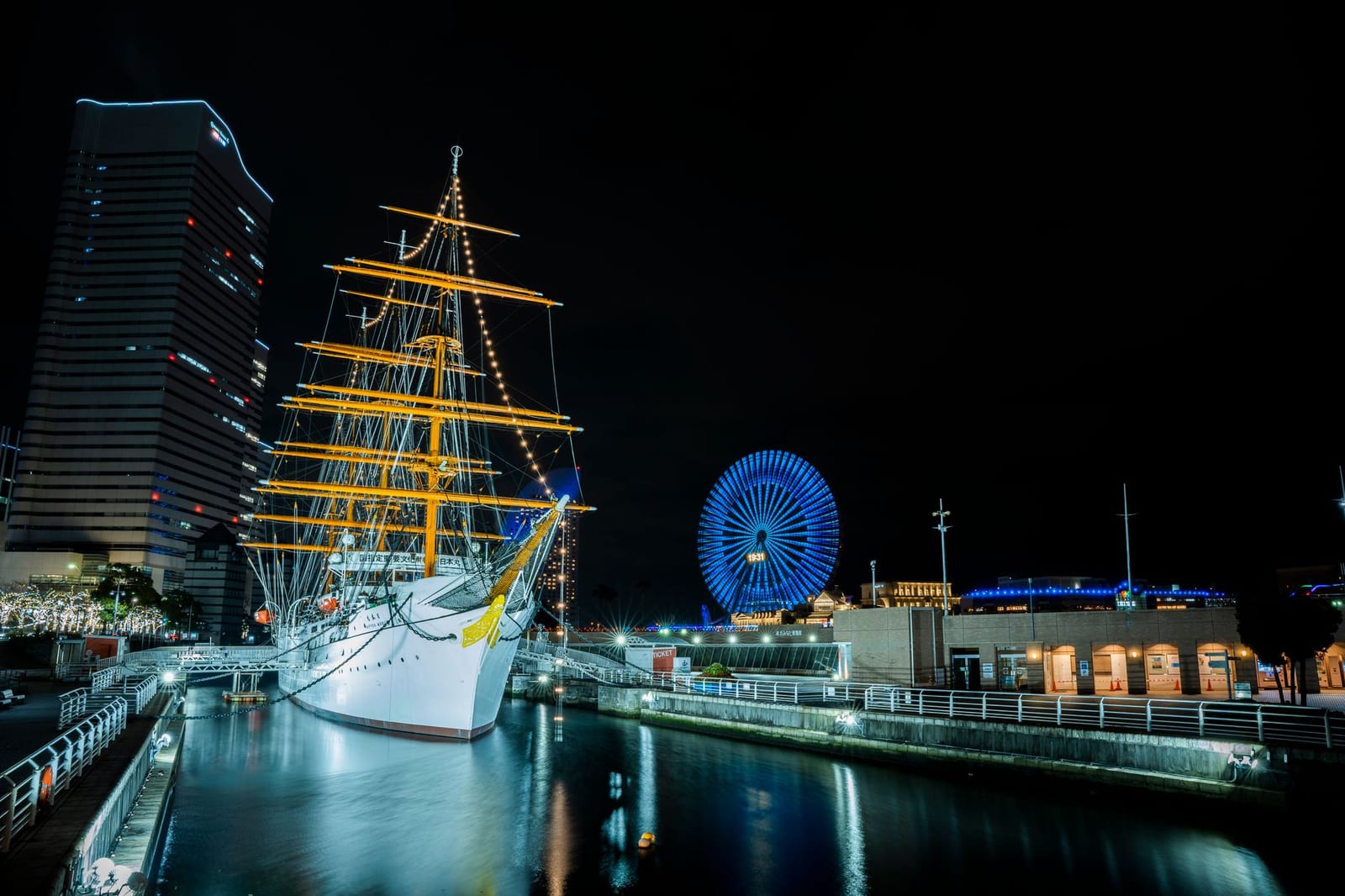 Yokohama harbour at night with the illuminated Ferris wheel on the waterfront